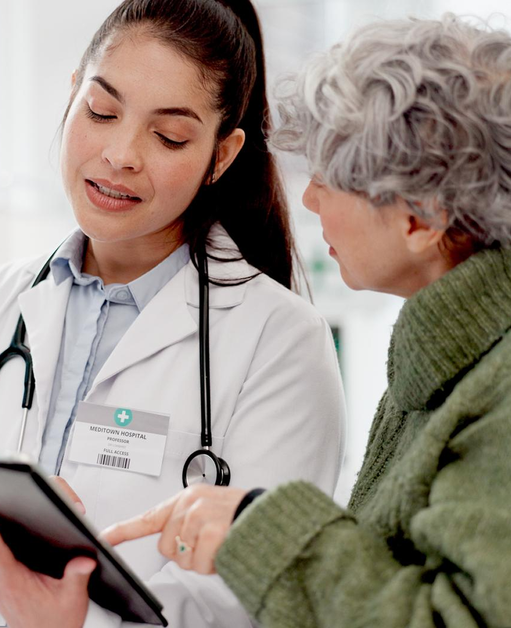 A clinician comforting an older adult patient